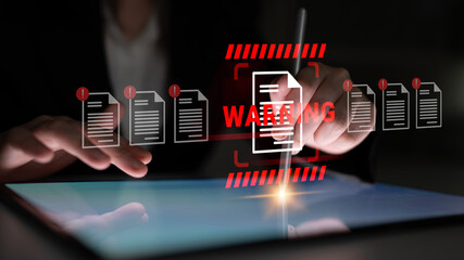 A business professional uses a tablet to address important data risks, emphasizing security awareness through visual warning signs and digital interaction strategies. Gantry