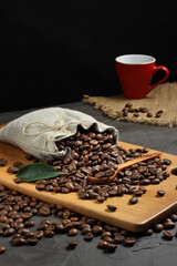 coffee beans in linen bag.beans and cap on concret background