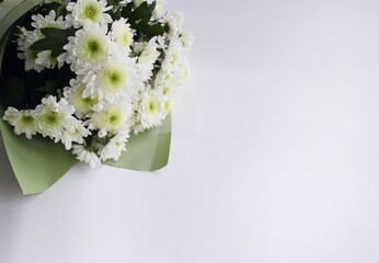 Festive bouquet with white chrysanthemums on a white background with a place for text. Background for congratulations, invitations.