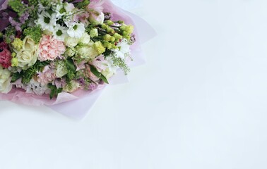 Festive bouquet of various colors on a white background with a place for text. Background for congratulations, invitations.
