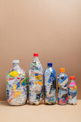 Five Plastic Bottles Filled with Compressed Recycled Waste