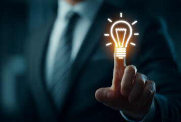 businessman touching a glowing light bulb icon, representing the concept of business and creativity