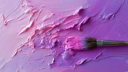 Mixing shades of pink with a paintbrush on a canvas in a creative space