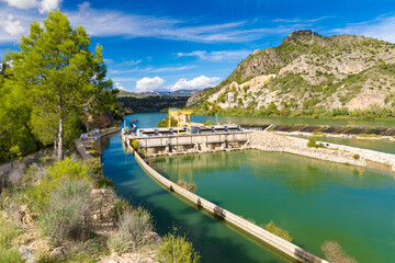 Scenic view of the Xerta Weir (Azud de Xerta) on the Ebro river in Catalonia, Spain, featuring a...