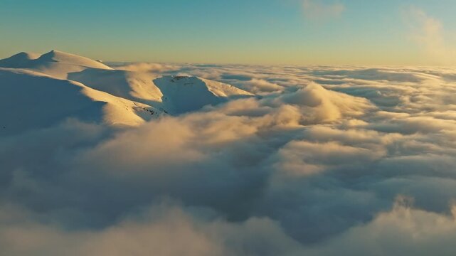 Morning mountain glow, Sunrise illuminates icy mountain tops, Bright dawn over snowcovered mountain peaks and fog, Early light bathes icy summits with mist drifting around