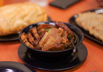 Braised Pork Belly Meal with Bread on Restaurant Table
