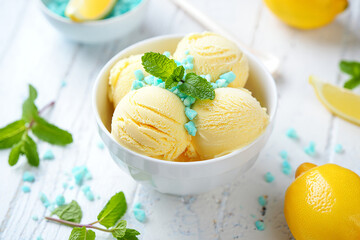 Ice cream with fruits mint lemon in a bowl on a plate