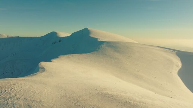 Vast snowcovered plateau featuring winding ridges and distant panoramic views, Expansive icy mountain expanse with undulating ridges and breathtaking distant scenery spaces
