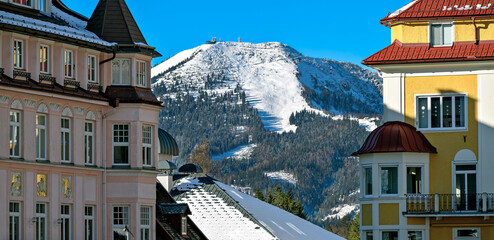 View from the main square in Mariazell towards the snow-covered peak of the Gemeindealpe with ski slope, Austria