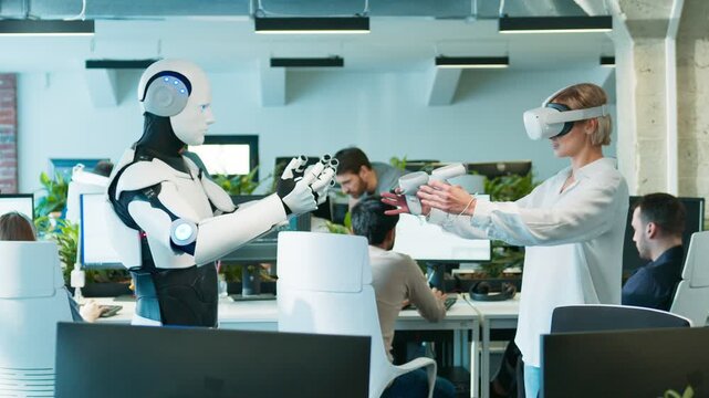 Female engineer guiding humanoid with VR controls. Woman raising hands while robot mirroring gesture. Motion sync test unfolding smoothly as staff continue working. Spacious tech office.