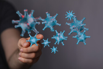 Illustrative image of microscopic Coronavirus molecules near a hand, conveying concept of health, viruses, and