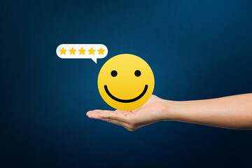 Excellent, service rating, positive feedback and satisfaction. Hand holding smile face emoticon indicating satisfaction level of service users