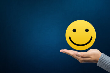 Excellent, service rating, positive feedback and satisfaction. Hand holding smile face emoticon indicating satisfaction level of service users