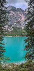 Fototapeten Khaki A beautiful view of Lake Braies, Italy, South Tyrol. The mountain lake with crystal clear, cold water on an overcast day.  © Артем Лукин