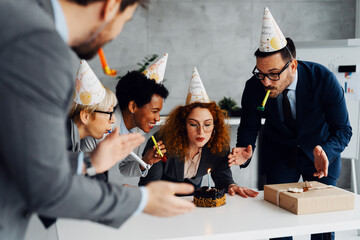 Business Colleagues Celebrating a Birthday with a Cake in the Office