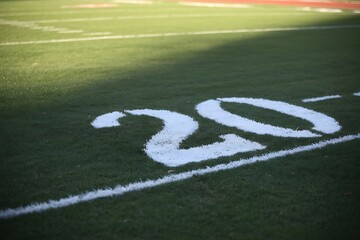 Close-up View of the Number 20 Painted White on a Lush Green Football Field