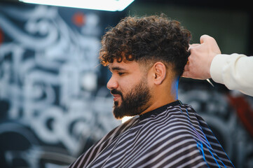 Man getting fresh haircut and beard groomed at barbershop