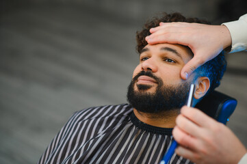 Man receiving beard shave and grooming service
