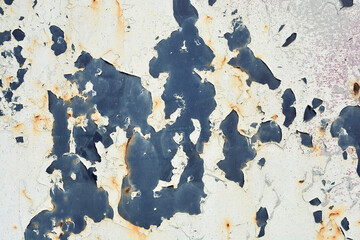 A close-up, full-frame abstract background of peeling white paint flaking away from the underlying...