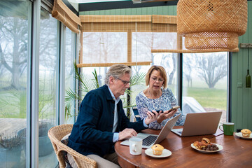 Senior couple focused on online banking at home