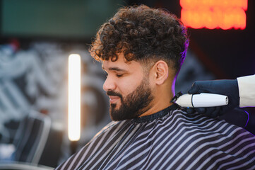 Man getting fresh haircut and beard trim in barbershop