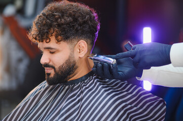 Man getting haircut and beard trim in barbershop