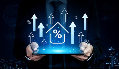 A businessman holds a tablet displaying a graphic of upward trends, house icons, and percentages. This visual represents financial growth and real estate market insights for professionals. Gantry