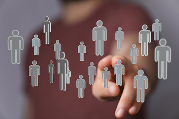 Hand pointing at connected people icons representing social media and business networks, perfect for teamwork a