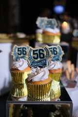 Cupcakes with 56 generación toppers celebrating milestone event