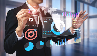 An engaged business professional interacts with a futuristic interface, analyzing digital graphs...