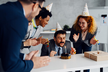 Business Colleagues Celebrating a Birthday with a Cake in the Office