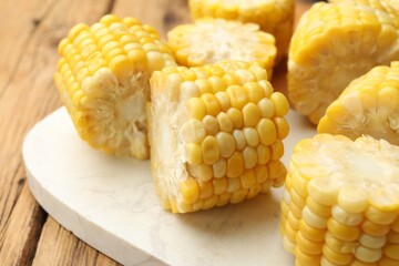 Pieces of boiled corn cobs on wooden table, closeup