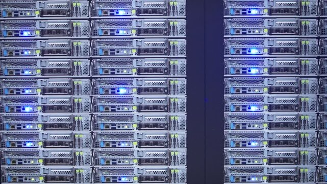 Slow motion of AI server racks blinking with blue LED lights in a dark room, showcasing high-performance computing infrastructure.