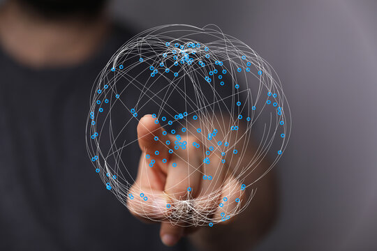 Close-up of a person's hand touching a digital globe symbolizing global connection and network. Technology concept, data visualizatio - Powered by Adobe
