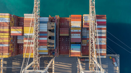 Top-down view of containers in the commercial port of Koper. Abstract aerial view of a key location for industry, the economy, and trade in Slovenia and Europe