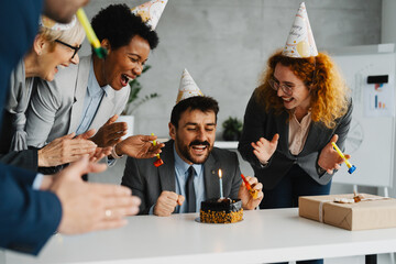 Business Colleagues Celebrating a Birthday with a Cake in the Office