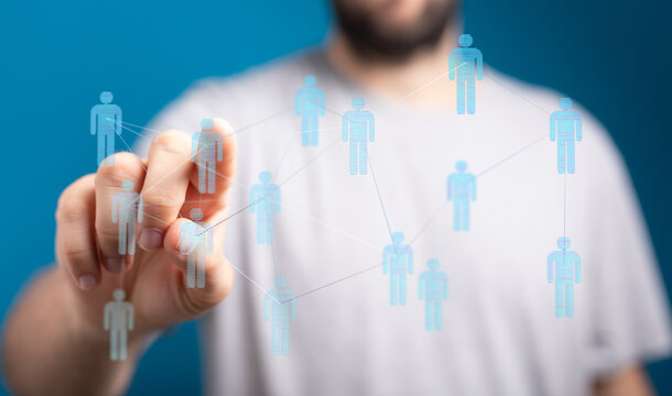 Person touching a digital network interface of interconnected people representing the concept of social connection, networking and community. - Powered by Adobe