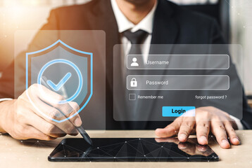 A businessman is using a digital tablet for secure login, featuring a username and password entry alongside a graphical security shield overlay for authentication. Gantry