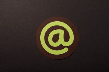 Stylish graphic of the at symbol used in email addresses, crafted from paper. Great for design and technology.