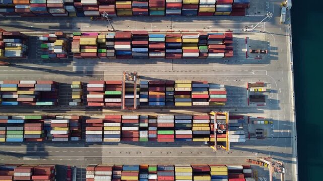 Top-down view of containers in the commercial port of Koper. Abstract aerial view of a key location for industry, the economy, and trade in Slovenia and Europe