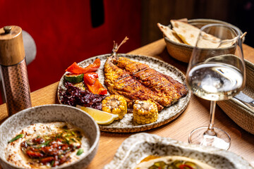 Halal tatar grilled mackerel with hummus and vegetables