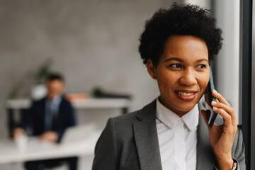 African American Businesswoman Using Smartphone in Office