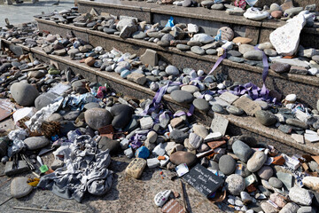 Several stones bearing the names of deceased individuals were placed in their honor on the steps of...