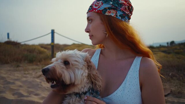 Redhead woman hugging doodle dog showing affection