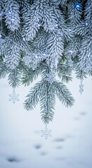 Close-up of frosty fir branches with snowflake ornaments and string lights, creating a festive, cold, and decorative showcase for winter holiday