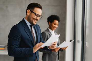 Diverse Business Colleagues Reviewing Documents in Office