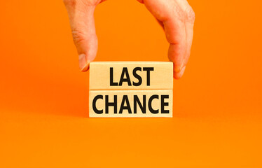 Last chance symbol. Concept word Last chance on beautiful wooden blocks. Beautiful orange paper...