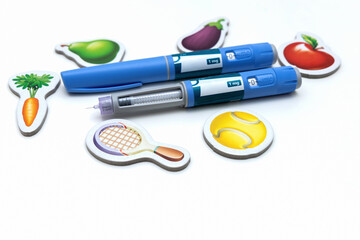 Weight loss concept Ozimpic pen with healthy food and sports symbols