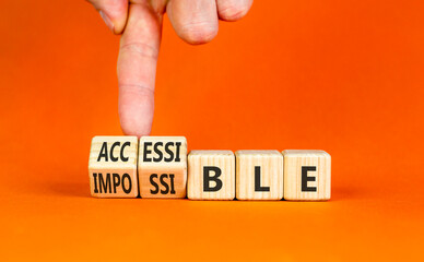 Accessible or impossible symbol. Concept words Accessible or Impossible on beautiful wooden blocks. Beautiful orange table orange background. Business accessible or impossible concept. Copy space.