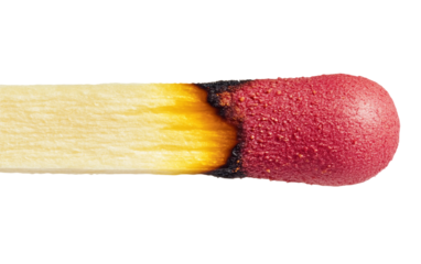 Hand-held matchstick captured in close up emphasizing gentle flame and light intensity